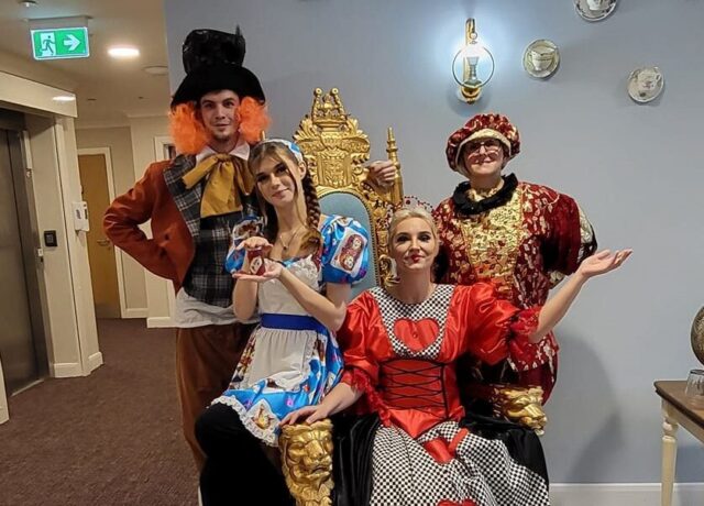 staff dressed up as alice in wonderland characters